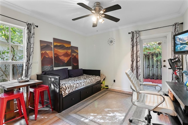 bedroom featuring ceiling fan, hardwood / wood-style floors, and ornamental molding