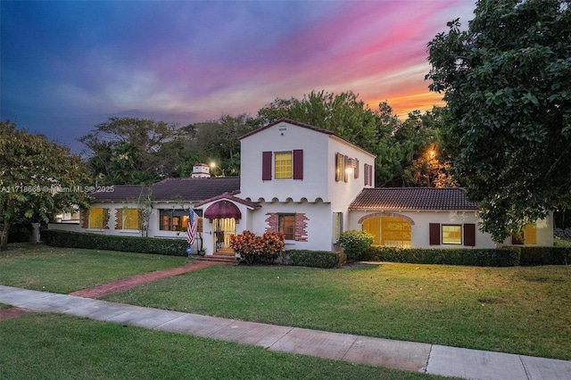 mediterranean / spanish-style home with a yard