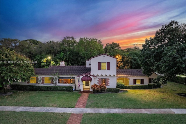 mediterranean / spanish house with a lawn