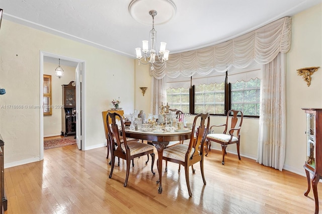 dining space featuring hardwood / wood-style flooring and a notable chandelier