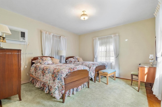 carpeted bedroom featuring a wall mounted AC