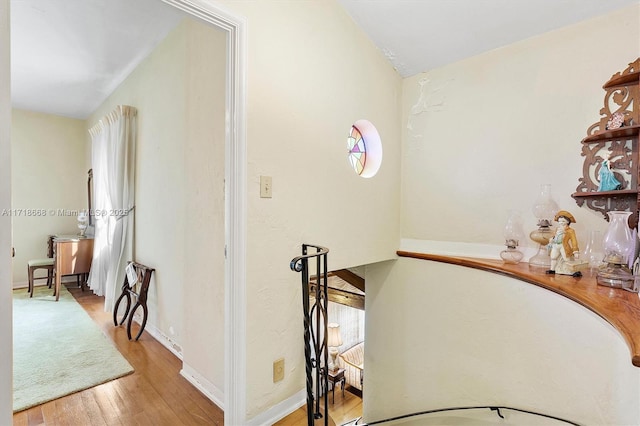 corridor with light hardwood / wood-style flooring