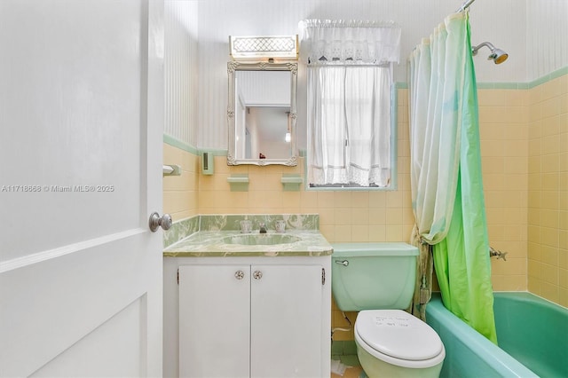 full bathroom featuring shower / bath combination with curtain, vanity, toilet, and tile walls