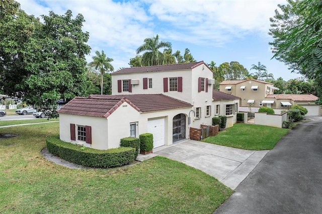 mediterranean / spanish-style home with a front yard and a garage