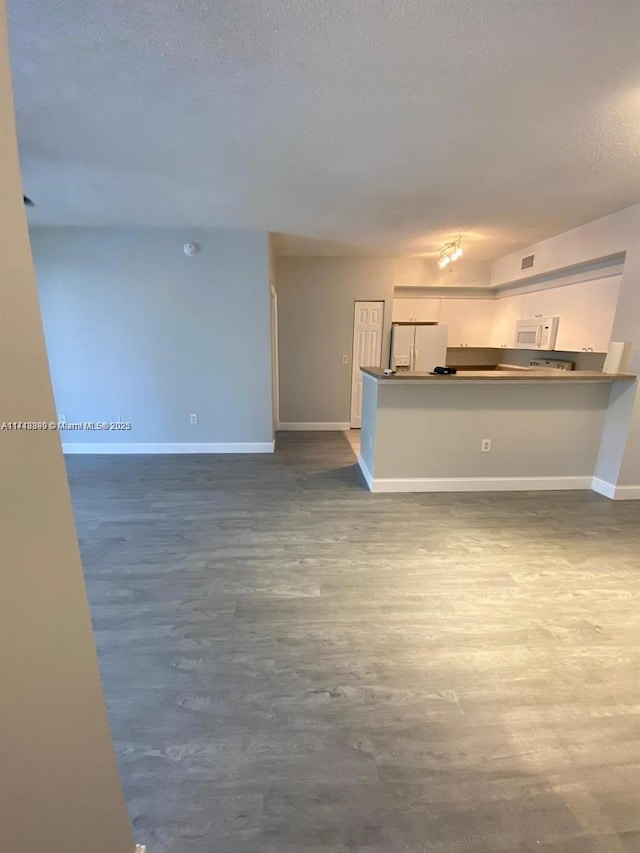 unfurnished living room with a textured ceiling