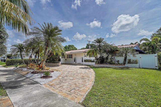 mediterranean / spanish-style house with a front lawn