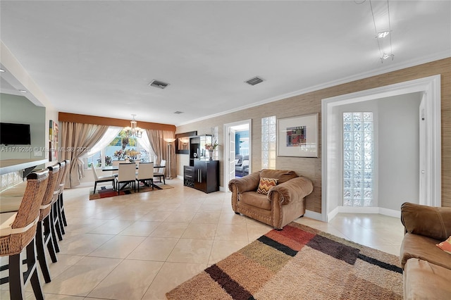 living room featuring crown molding, light tile patterned floors, and a chandelier