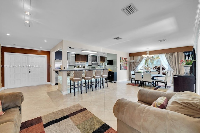 tiled living room featuring a notable chandelier