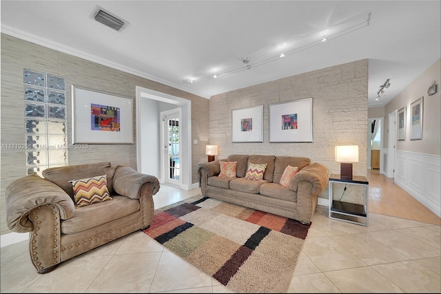 living room with light tile patterned floors and rail lighting