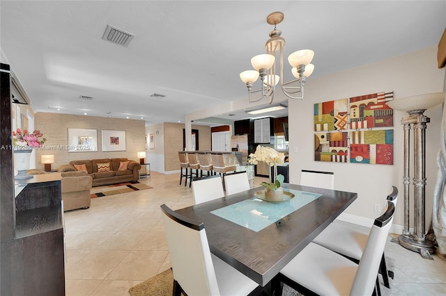 tiled dining space with a notable chandelier