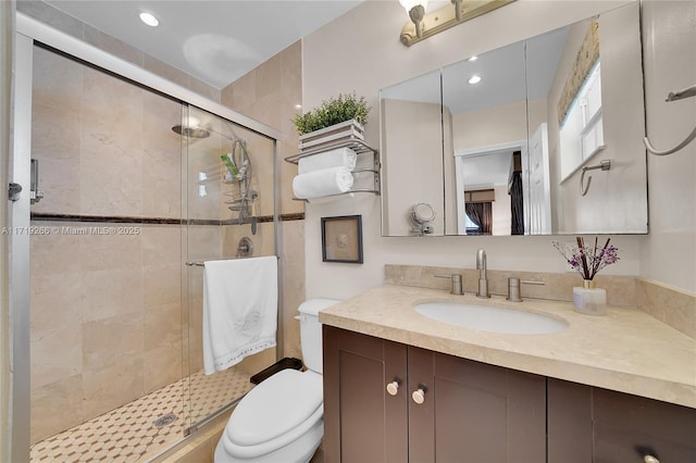 bathroom with vanity, toilet, and walk in shower