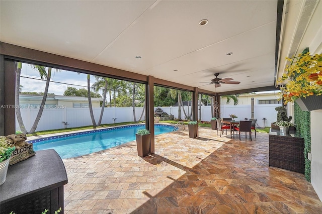 view of swimming pool with ceiling fan and a patio