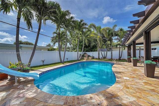 view of pool featuring a patio area and a water slide