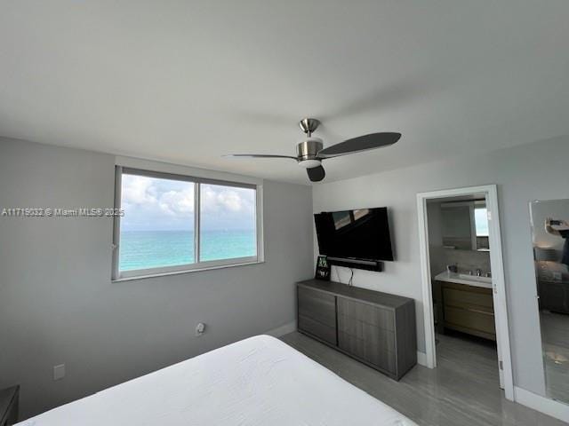 bedroom with ensuite bath and ceiling fan