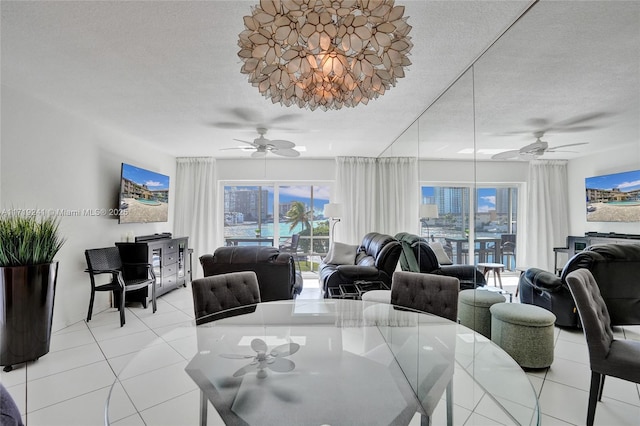 dining space featuring light tile patterned floors, ceiling fan, and plenty of natural light