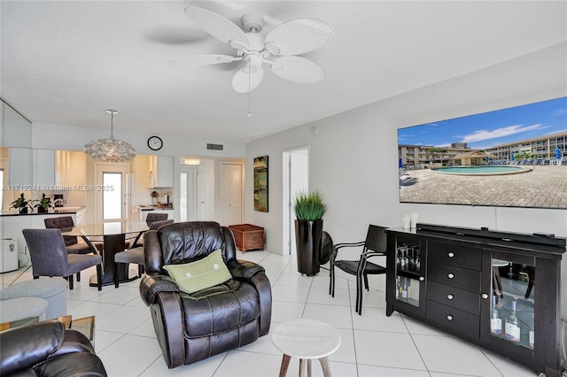 living room with visible vents, a ceiling fan, and light tile patterned floors