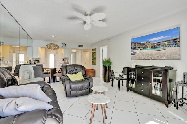 living room with a ceiling fan and light tile patterned flooring