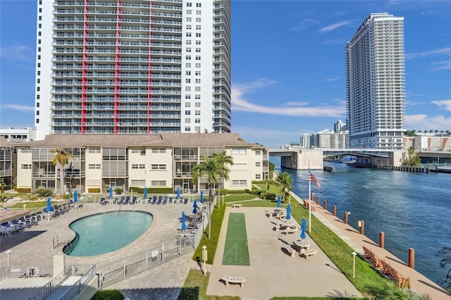 pool with a city view, a water view, a patio area, and shuffleboard