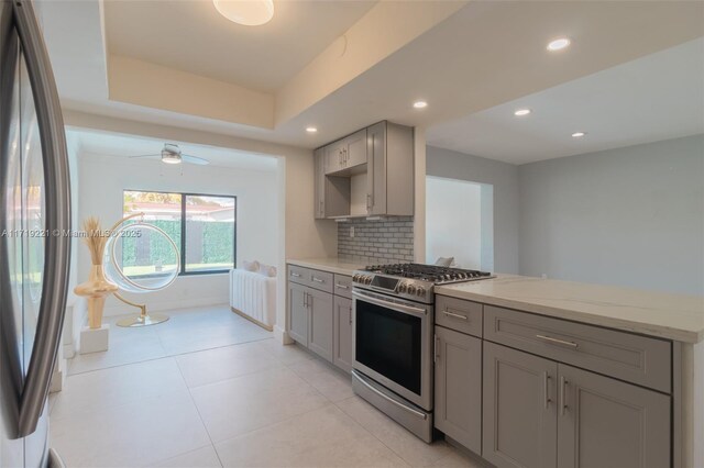 kitchen featuring washer / dryer, gray cabinets, backsplash, and sink