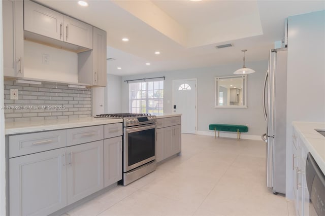 kitchen featuring stainless steel appliances, recessed lighting, gray cabinetry, and tasteful backsplash