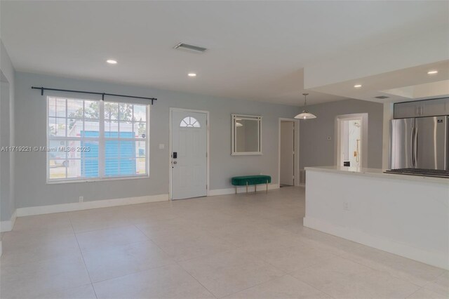 bathroom featuring a tile shower, toilet, vanity, and tile patterned floors