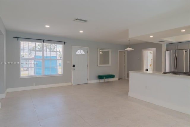 entryway featuring light tile patterned flooring, recessed lighting, visible vents, and baseboards