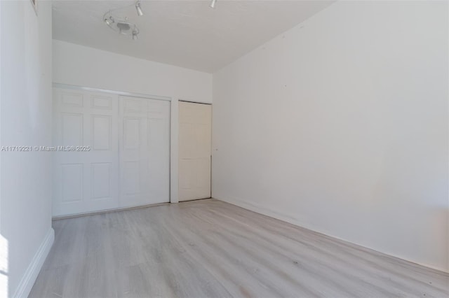 unfurnished bedroom featuring light wood finished floors