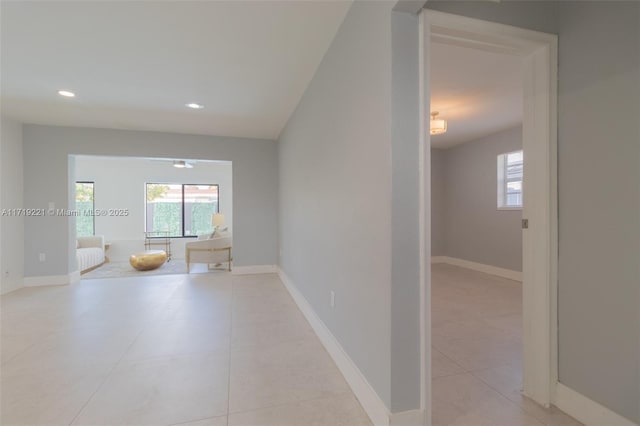 unfurnished room with light tile patterned floors, recessed lighting, and baseboards