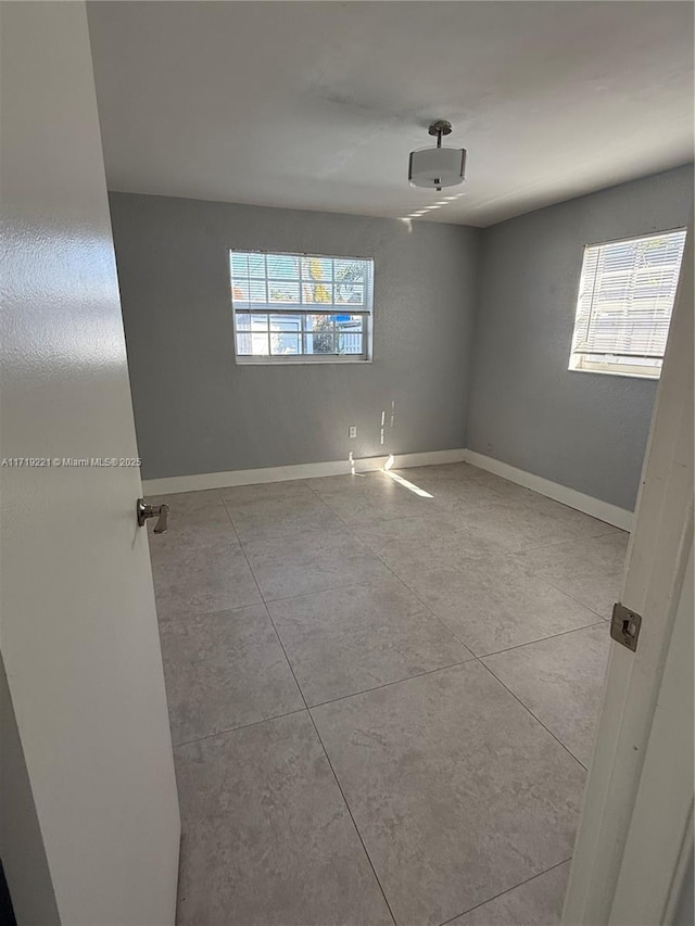 tiled empty room with plenty of natural light