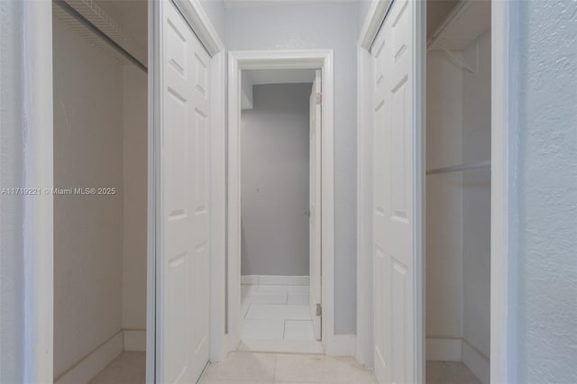 hall featuring light tile patterned floors