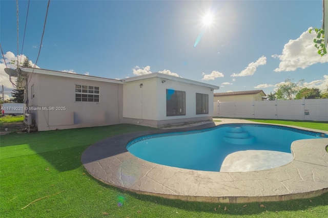 view of pool with a yard, fence, and a fenced in pool