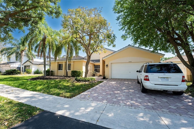 ranch-style house with a garage and a front yard