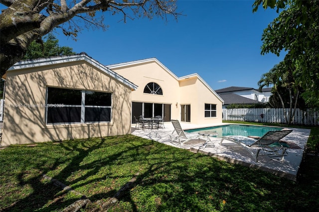 13080 NW 8th Ct, Sunrise, FL 33325 - rear view of house featuring stucco siding and a patio area