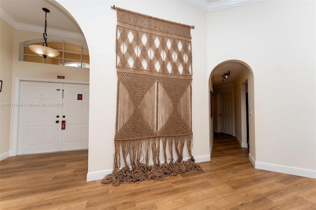 13080 NW 8th Ct, Sunrise, FL 33325 - mudroom with arched walkways, a towering ceiling, crown molding, and wood finished floors
