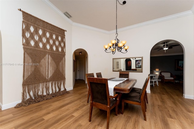 13080 NW 8th Ct, Sunrise, FL 33325 - dining space featuring arched walkways, crown molding, light wood-type flooring, a chandelier, and ceiling fan