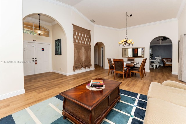 13080 NW 8th Ct, Sunrise, FL 33325 - living room with arched walkways, a chandelier, crown molding, and wood finished floors