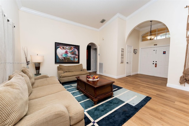 13080 NW 8th Ct, Sunrise, FL 33325 - living area featuring arched walkways, wood finished floors, and crown molding