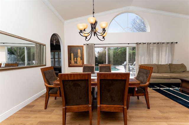 13080 NW 8th Ct, Sunrise, FL 33325 - dining room featuring a chandelier, healthy amount of natural light, light wood finished floors, crown molding, and high vaulted ceiling