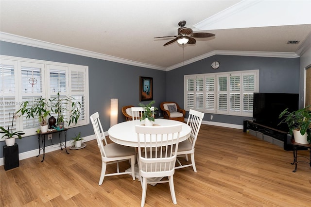 13080 NW 8th Ct, Sunrise, FL 33325 - dining area featuring a ceiling fan, light wood-style floors, healthy amount of natural light, lofted ceiling, and ornamental molding
