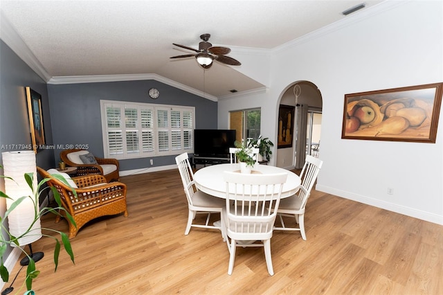 13080 NW 8th Ct, Sunrise, FL 33325 - dining area featuring a ceiling fan, arched walkways, light wood-type flooring, lofted ceiling, and crown molding