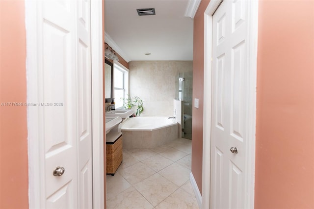 13080 NW 8th Ct, Sunrise, FL 33325 - bathroom featuring tiled tub, ornamental molding, tile patterned floors, vanity, and a closet