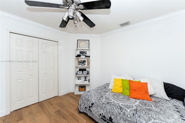 13080 NW 8th Ct, Sunrise, FL 33325 - bedroom featuring crown molding, wood finished floors, a closet, and a ceiling fan