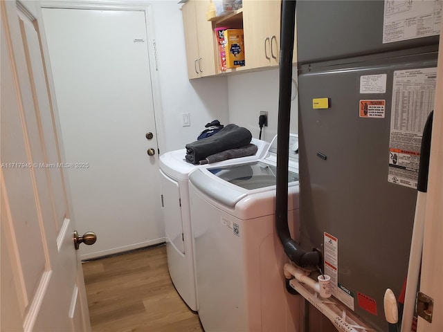 13080 NW 8th Ct, Sunrise, FL 33325 - laundry room with washing machine and clothes dryer, cabinet space, and light wood-type flooring