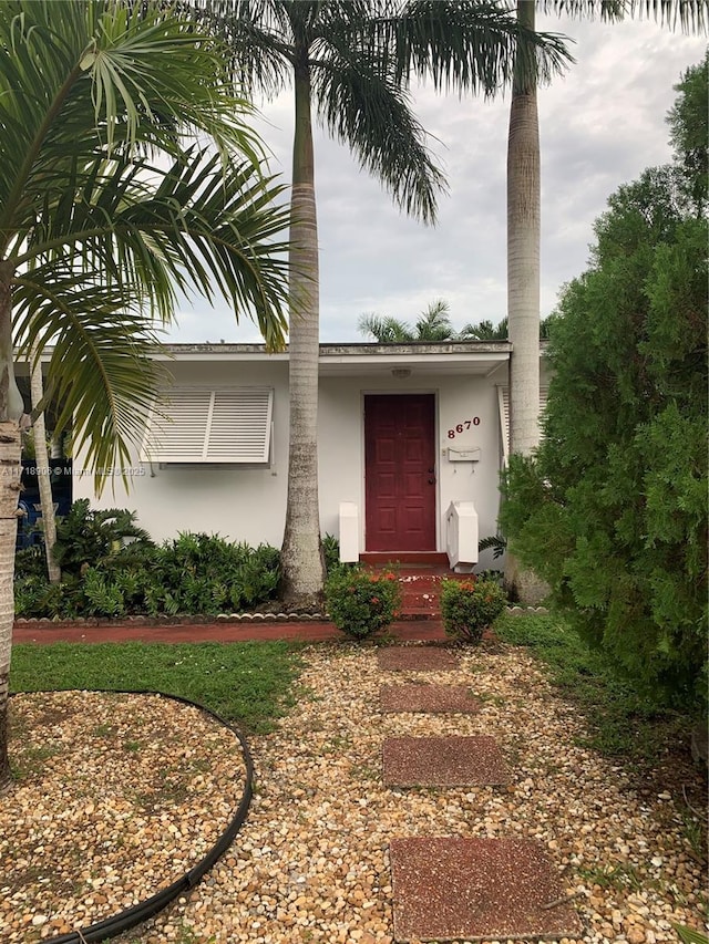 doorway to property with stucco siding