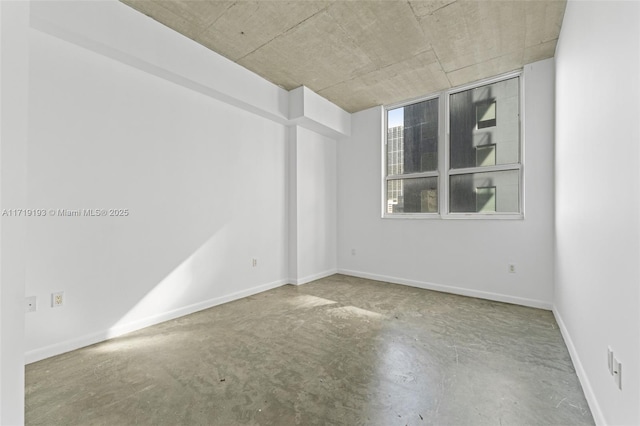 spare room with concrete flooring