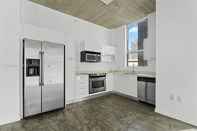 kitchen featuring white cabinetry, stainless steel appliances, and sink