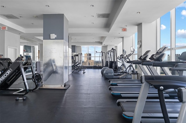 workout area with a wall of windows and a healthy amount of sunlight