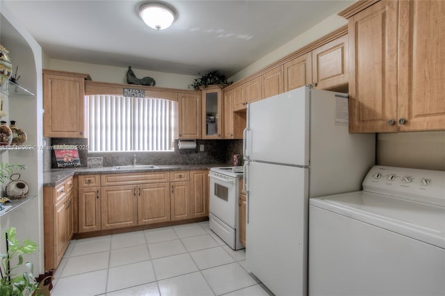 kitchen featuring white appliances, sink, light tile patterned floors, tasteful backsplash, and washer / dryer