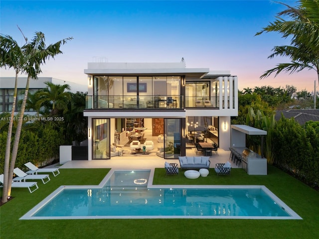 315 N Shore Dr, Miami Beach, FL 33141 - rear view of property featuring a yard, an outdoor pool, a patio, and a balcony