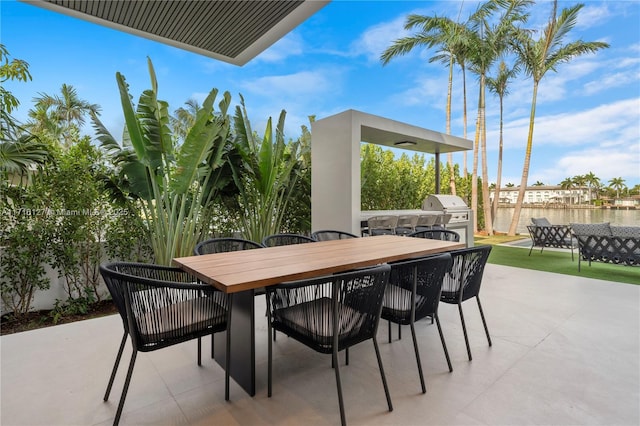 315 N Shore Dr, Miami Beach, FL 33141 - view of patio / terrace with outdoor dining space, a water view, a grill, and fence